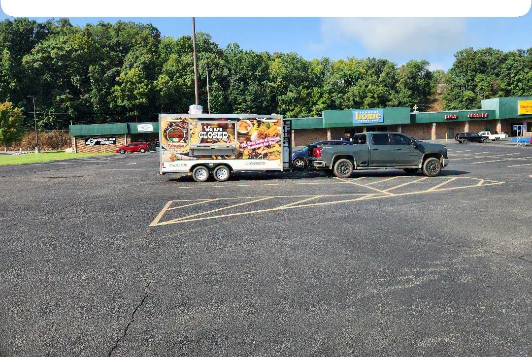 The food truck parked in a lot outside Farmers Home Furniture.