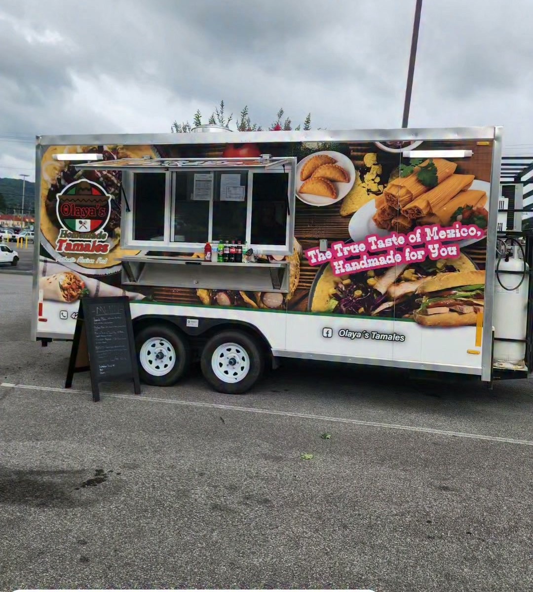 The Olaya's Tamales truck open and ready to serve, with the menu board out front.