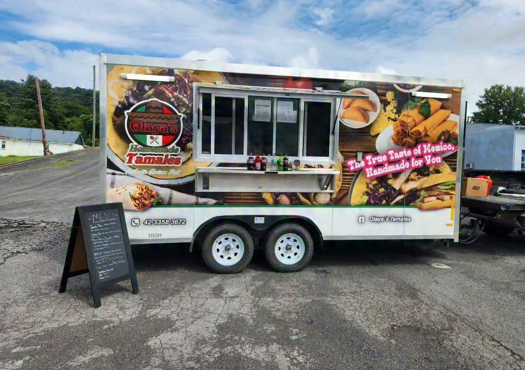 The Olaya's Tamales truck parked with its chalkboard menu outside.